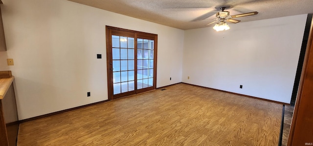 interior space with a textured ceiling, light hardwood / wood-style floors, and ceiling fan