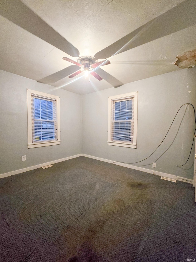 unfurnished room with ceiling fan and carpet floors