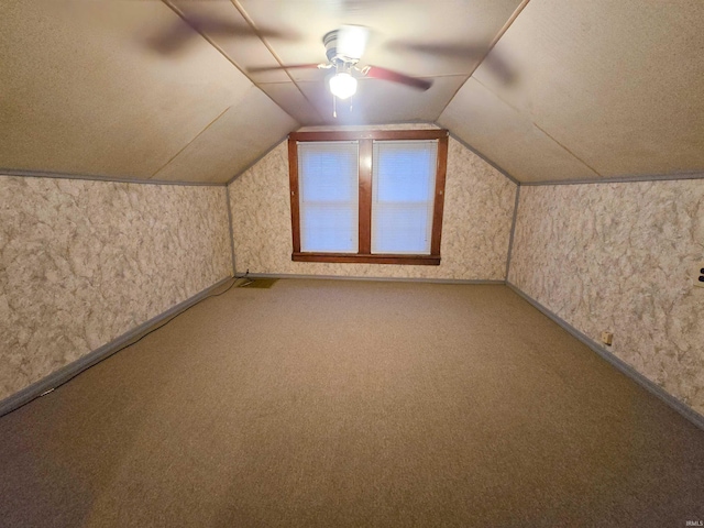 bonus room featuring carpet and vaulted ceiling