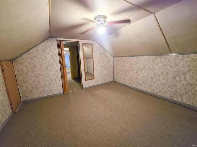 additional living space with ceiling fan and vaulted ceiling