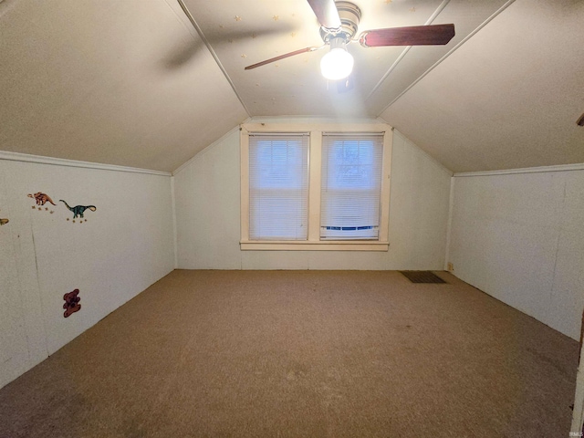 additional living space with carpet flooring, vaulted ceiling, and ceiling fan