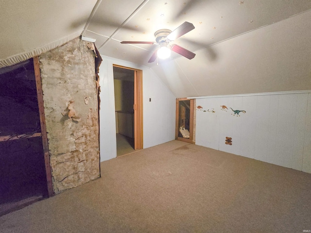 additional living space with ceiling fan, carpet floors, and vaulted ceiling