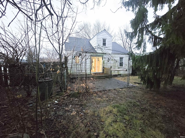 rear view of property featuring a deck