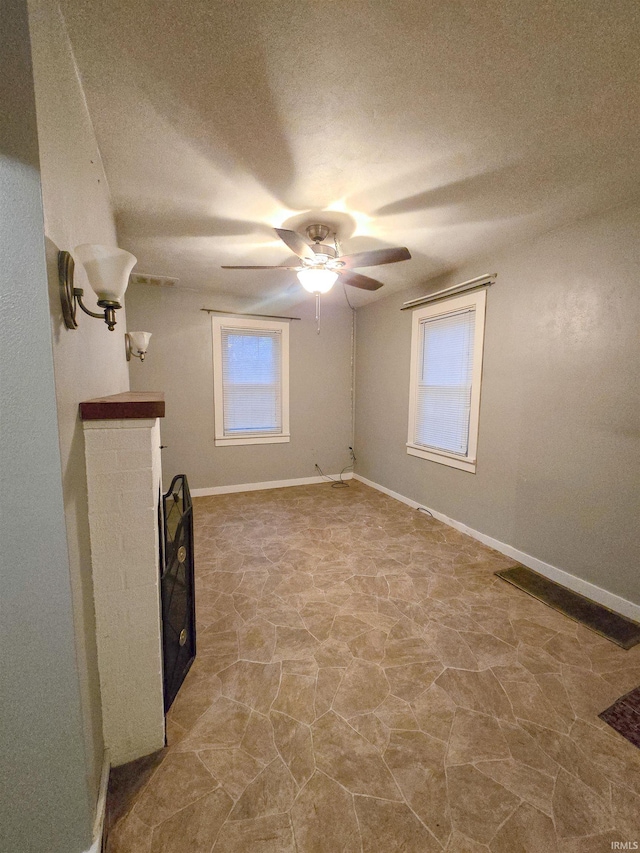 unfurnished living room featuring ceiling fan