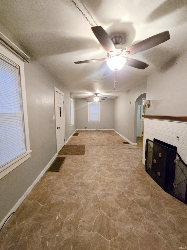 interior space with ceiling fan