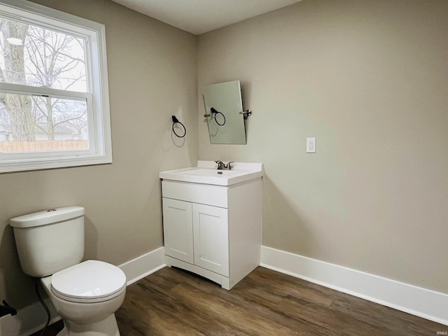 bathroom with hardwood / wood-style floors, vanity, and toilet