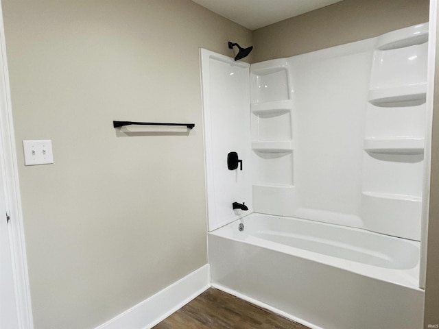 bathroom with shower / washtub combination and wood-type flooring