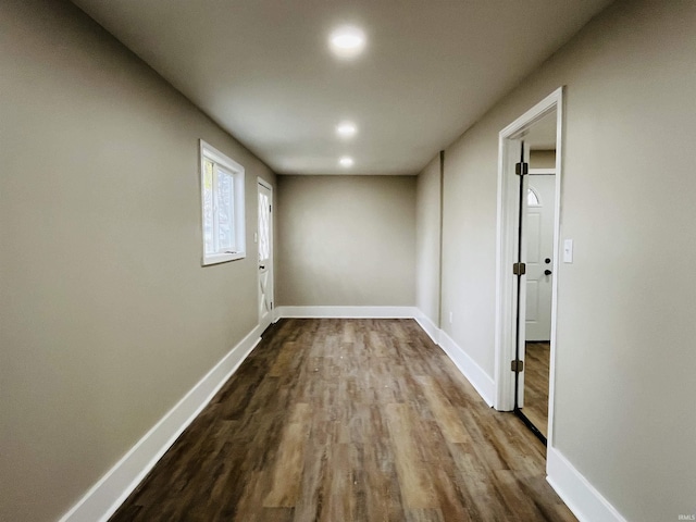 corridor with hardwood / wood-style flooring