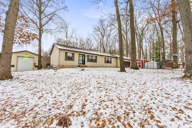 single story home featuring a garage and a storage unit