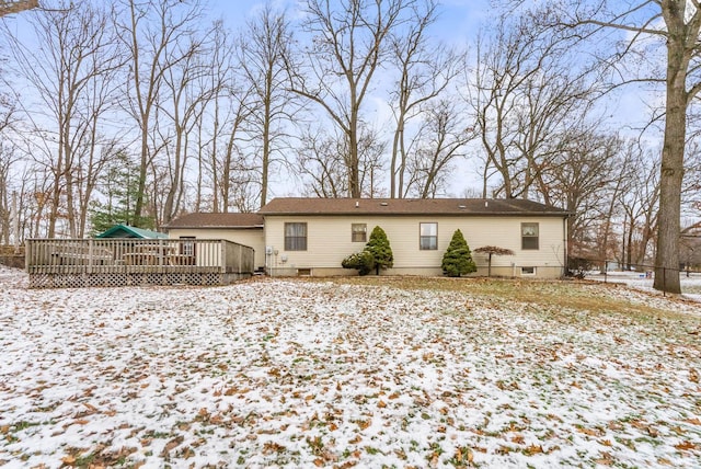 snow covered house featuring a deck