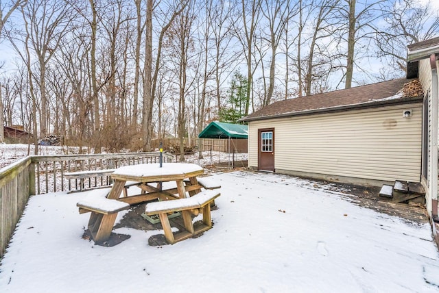 snowy yard with a wooden deck