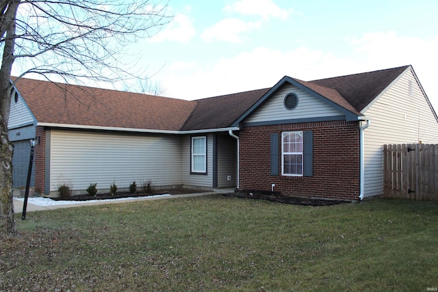 ranch-style house with a front yard and a garage