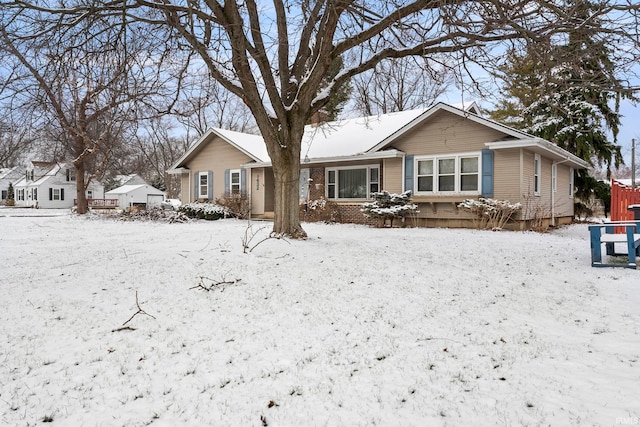 view of snow covered rear of property