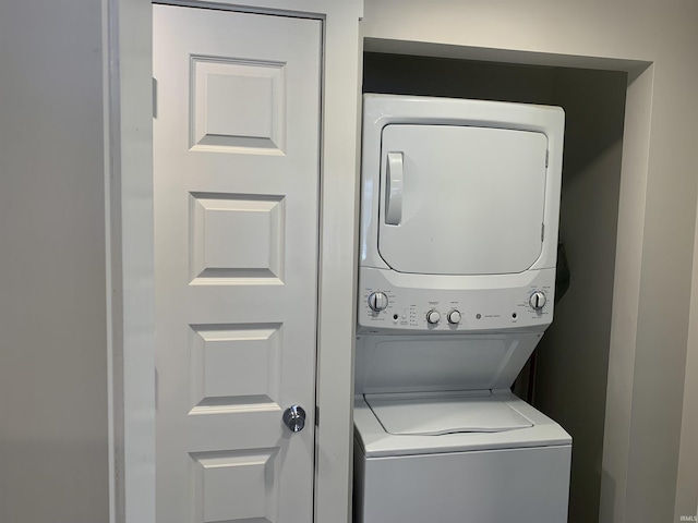 laundry area featuring stacked washing maching and dryer