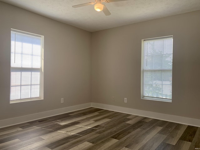 empty room featuring a textured ceiling, dark hardwood / wood-style flooring, and ceiling fan