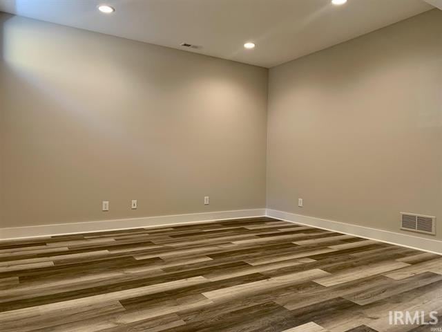 empty room with dark hardwood / wood-style flooring