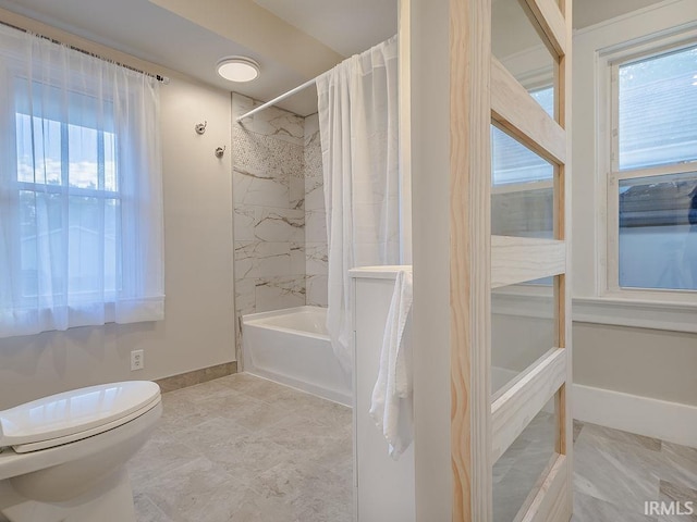 bathroom featuring shower / bath combo and toilet