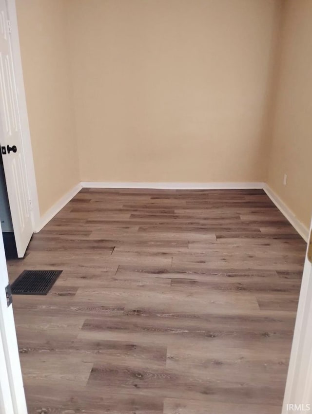 empty room featuring hardwood / wood-style flooring