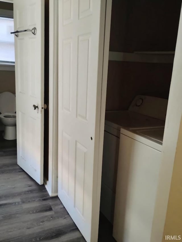 laundry room featuring washing machine and dryer and dark hardwood / wood-style floors