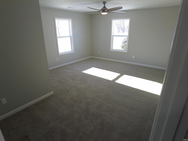 empty room with ceiling fan and carpet floors