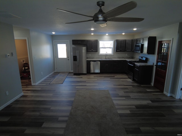 kitchen featuring ceiling fan, dark hardwood / wood-style flooring, sink, and appliances with stainless steel finishes