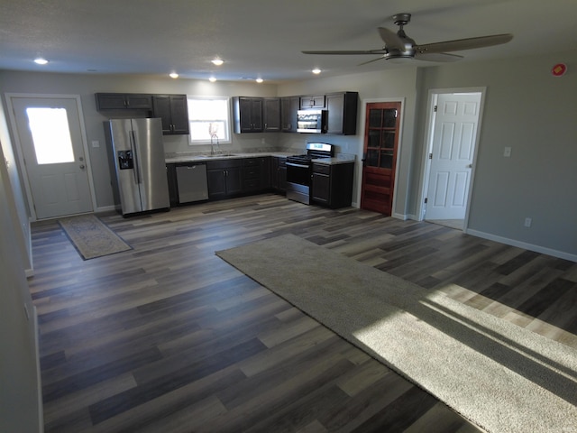 kitchen featuring ceiling fan, sink, dark wood-type flooring, and appliances with stainless steel finishes