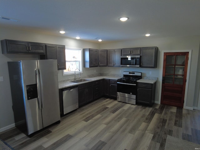 kitchen with dark wood-type flooring, sink, and stainless steel appliances