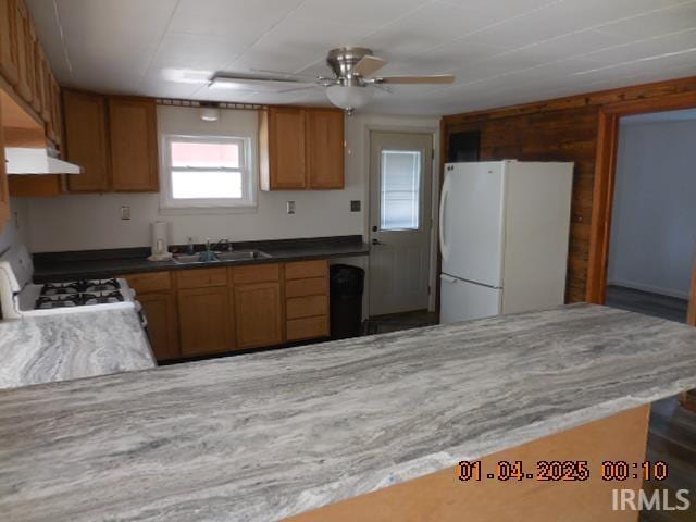 kitchen featuring ceiling fan, white appliances, and sink