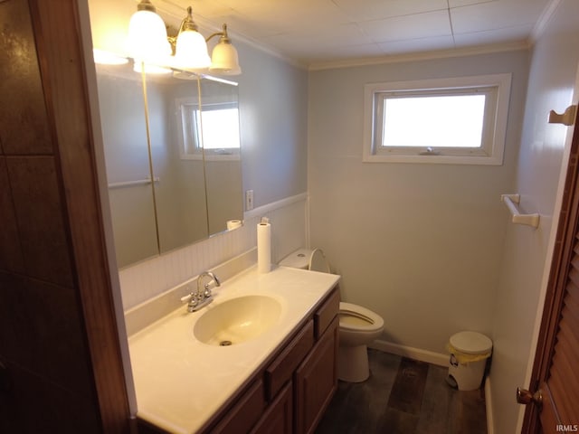 bathroom featuring hardwood / wood-style floors, vanity, toilet, and crown molding