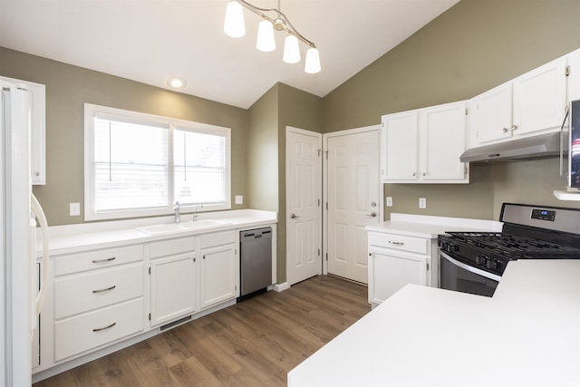 kitchen featuring white cabinetry, sink, stainless steel appliances, lofted ceiling, and decorative light fixtures