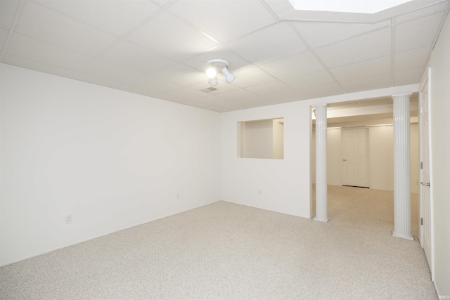 basement with a drop ceiling and light colored carpet