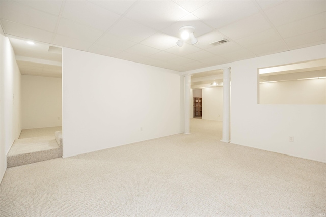 carpeted spare room with a drop ceiling