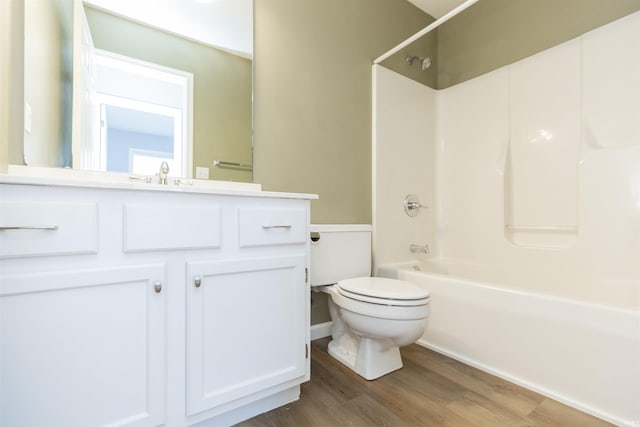 full bathroom featuring vanity, wood-type flooring,  shower combination, and toilet