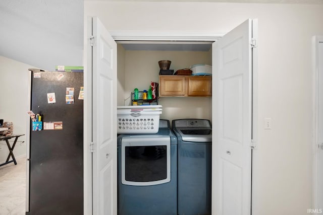 laundry area with cabinets and separate washer and dryer