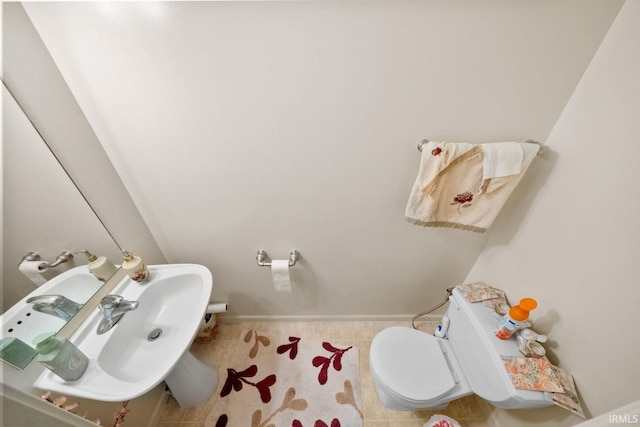 bathroom featuring tile patterned floors, sink, and toilet