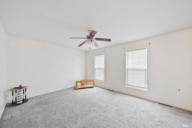 carpeted empty room with ceiling fan