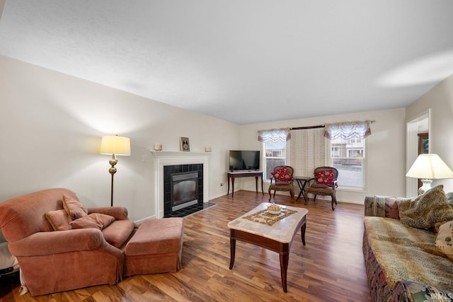 living room featuring hardwood / wood-style floors and a tile fireplace