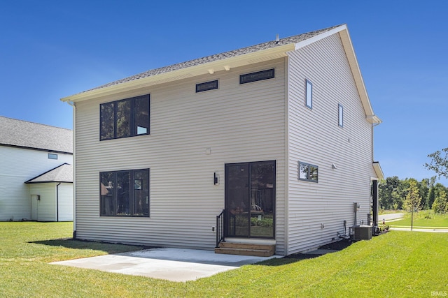 rear view of house with a lawn and a patio area