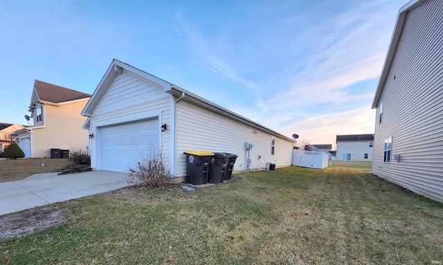 view of side of home with a yard and a garage