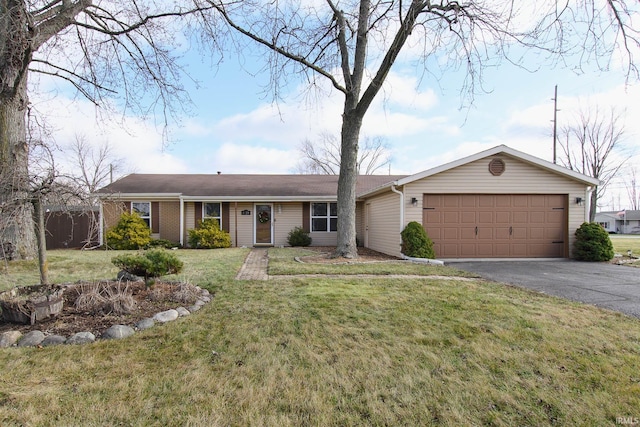 ranch-style home with a front lawn and a garage