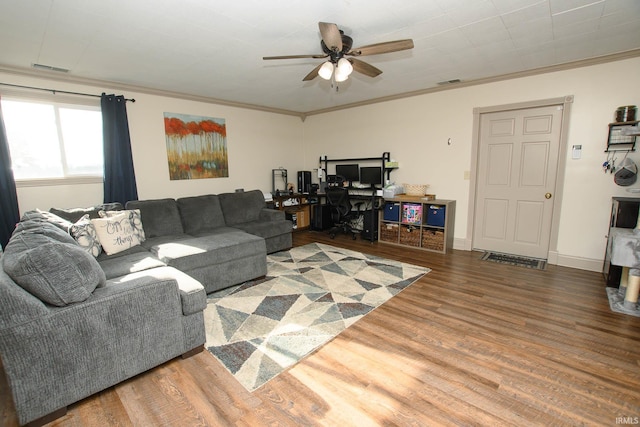 living room featuring hardwood / wood-style floors, ceiling fan, and ornamental molding