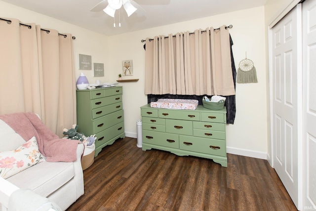 sitting room featuring ceiling fan and dark wood-type flooring