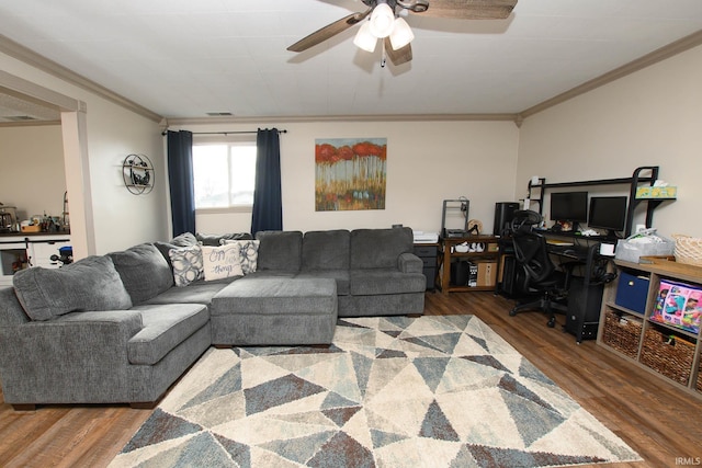 living room featuring crown molding, hardwood / wood-style floors, and ceiling fan