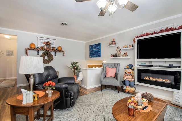 living room with hardwood / wood-style floors and ornamental molding