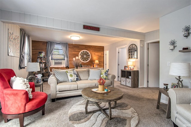 carpeted living room featuring wood walls