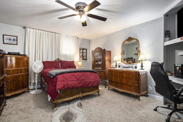 bedroom featuring baseboard heating, ceiling fan, and carpet