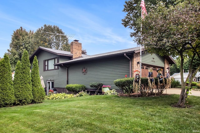 rear view of house with a garage and a lawn