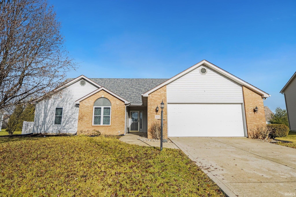 single story home featuring a garage and a front yard