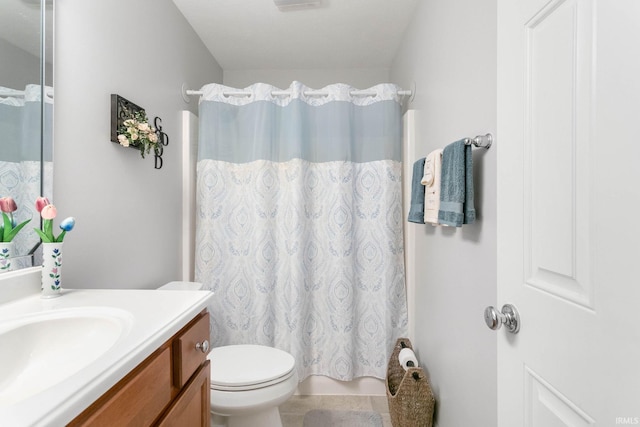 bathroom with vanity, toilet, and curtained shower