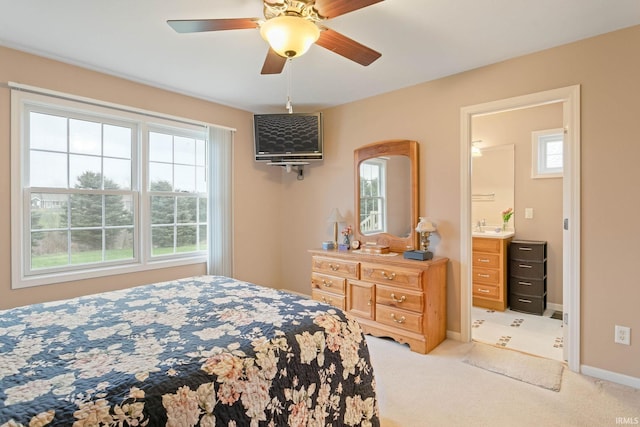 carpeted bedroom with connected bathroom and ceiling fan